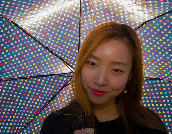 Portrait of So Hee holding an umbrella in Hanover, Germany
