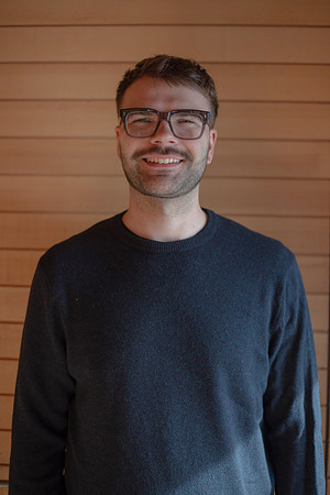 Professional headshot portrait of Quirin