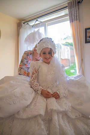 Detail photograph of a young girl's First Communion dress taken at a family home in Cork, Ireland by FlashFocus.org